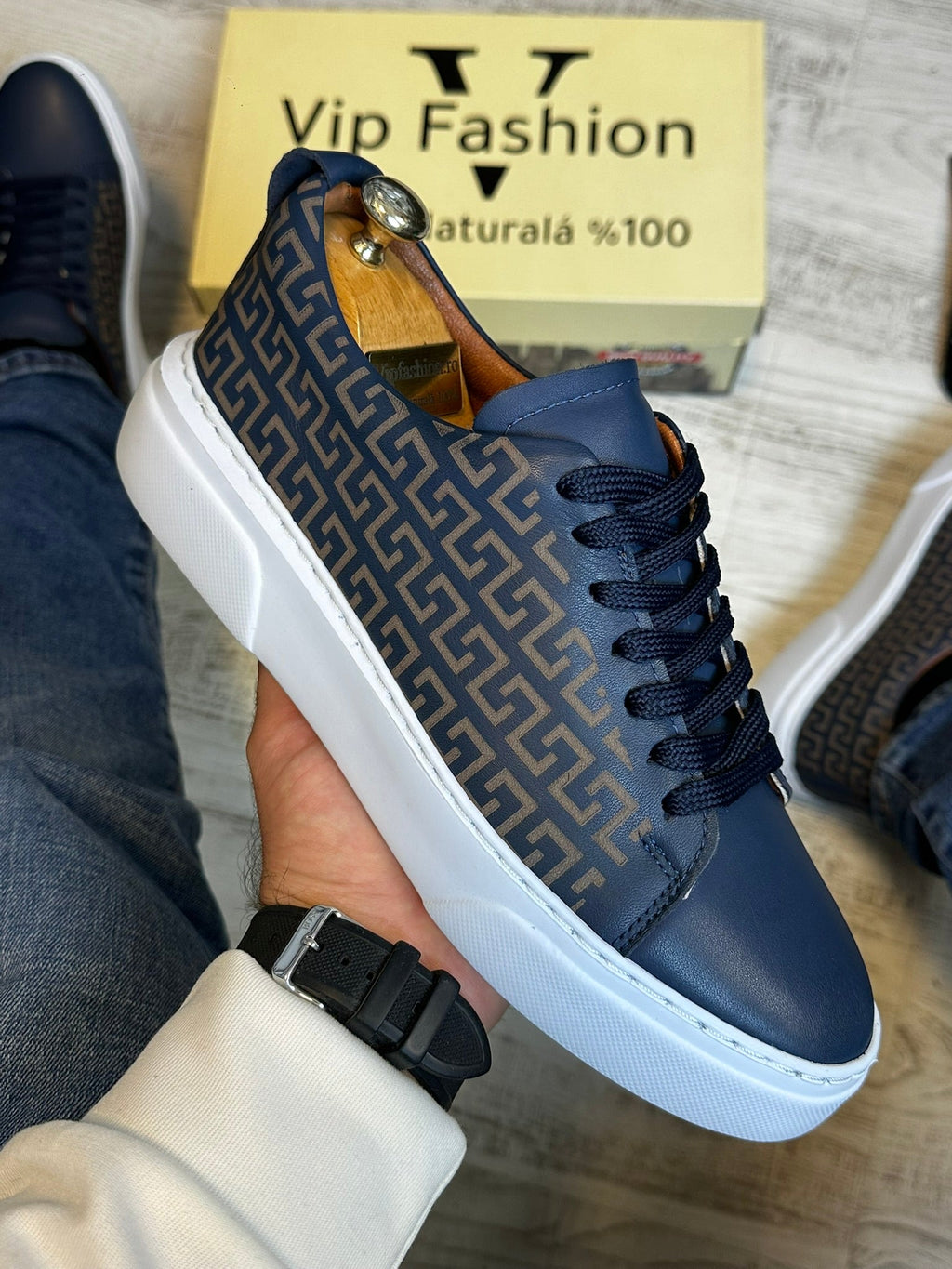 Blue sneaker with a pattern held by a hand, with 'Vip Fashion' box in the background.